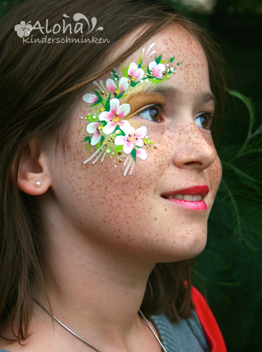 Flower fairy face painting with delicate motifs