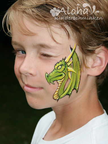 Dragon face painting in green and gold