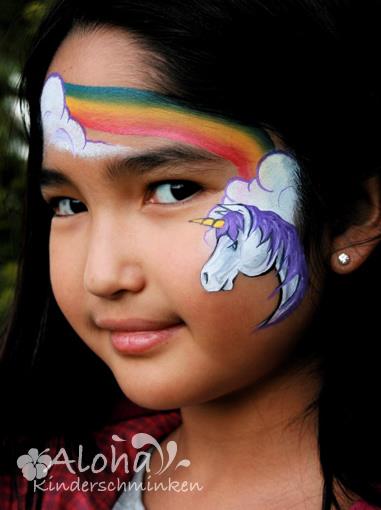 Unicorn face painting design with glitter accents