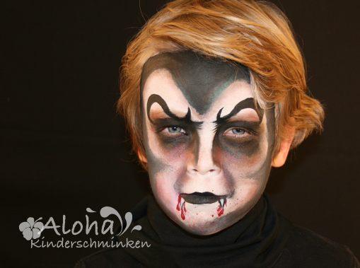 Vampire face painting for Halloween with dramatic details